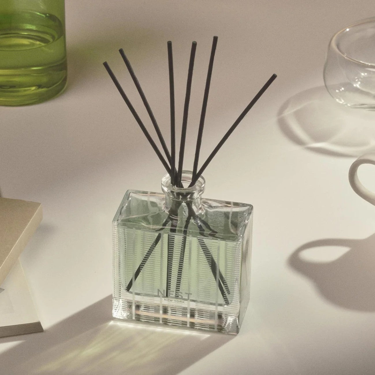 NEST Wild Mint & Eucalyptus reed diffuser on a sunlit table, from our 12 luxury reed diffuser test